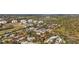 Aerial view of a community featuring homes, ponds, trees, and shrubs, set against a backdrop of the greater landscape at 7035 Duke St, Englewood, FL 34224