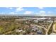 Scenic aerial view showcasing the light blue home's proximity to the water and town, perfect for coastal living at 7035 Duke St, Englewood, FL 34224