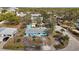 Overhead shot of a light blue single-story home with mature trees, offering privacy and a serene setting at 7035 Duke St, Englewood, FL 34224