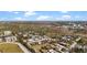 Expansive aerial view showing the location of the light blue home within a tranquil neighborhood surrounded by lush greenery at 7035 Duke St, Englewood, FL 34224