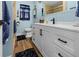 Bathroom with a white vanity, tile flooring and nautical decor at 7035 Duke St, Englewood, FL 34224