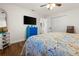 Comfortable bedroom featuring light walls, ceiling fan, wood-look floors, and closet for ample storage at 7035 Duke St, Englewood, FL 34224