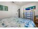 Bright bedroom featuring light walls, ceiling fan, wood-look floors, and tropical artwork at 7035 Duke St, Englewood, FL 34224