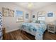 Bright bedroom features tile floor, dual windows, beach-themed décor, and a comfortable bed at 7035 Duke St, Englewood, FL 34224
