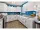 Bright kitchen with white cabinets, stainless steel appliances, and view to the breakfast area at 7035 Duke St, Englewood, FL 34224