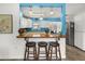 Modern kitchen with a breakfast bar overlooking the living area, perfect for casual dining and entertaining at 7035 Duke St, Englewood, FL 34224