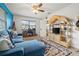 Inviting living room featuring blue accent wall, tile floor, and comfortable couch with ottoman at 7035 Duke St, Englewood, FL 34224