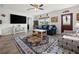 Spacious living room showcasing a large rug, comfortable furniture, and an open layout, perfect for relaxing or entertaining at 7035 Duke St, Englewood, FL 34224