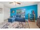 Inviting living room featuring blue accent wall, tile floor, and comfortable couch for relaxing at 7035 Duke St, Englewood, FL 34224