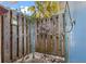 This outdoor shower area has a wood plank floor, a rustic privacy fence with decorations, and a shower head at 7035 Duke St, Englewood, FL 34224