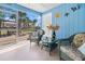Cozy sunroom with screen windows, wicker furniture, ceiling fan, and wood floor at 7035 Duke St, Englewood, FL 34224