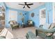 Bright sunroom featuring woven furniture, ceiling fan, and nautical decor at 7035 Duke St, Englewood, FL 34224