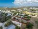 Beautiful home, outlined in red, sits on a spacious lot near a tranquil pond and surrounded by lush landscapes at 7035 York St, Englewood, FL 34224