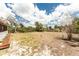 Large backyard featuring grass, mature trees, and a fence for privacy at 7035 York St, Englewood, FL 34224
