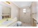 Updated bathroom features tiled shower, classic sink, and vanity, providing a functional and stylish space at 7035 York St, Englewood, FL 34224