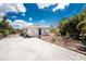 Inviting home featuring a gravel driveway and well-maintained landscaping at 7035 York St, Englewood, FL 34224