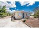 Charming home with a gravel driveway, a blue front door, and white shutters at 7035 York St, Englewood, FL 34224