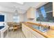 Bright kitchen with a double stainless steel sink, dining table, natural wood accents and updated appliances at 7035 York St, Englewood, FL 34224
