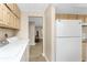 Laundry room with appliances and cabinets, offering convenient storage and utility space at 7035 York St, Englewood, FL 34224