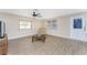 Bright living room features wood-look flooring, ceiling fan, and multiple windows at 7035 York St, Englewood, FL 34224
