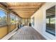 Enclosed patio featuring a wood floor and ceiling with walls of windows to the outside at 7035 York St, Englewood, FL 34224