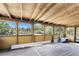 Enclosed patio featuring a wood floor and ceiling with walls of windows for natural light at 7035 York St, Englewood, FL 34224