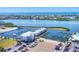 Expansive aerial view of a marina community, with boat docks, modern condos, and tranquil waters in the background at 7070 Placida Rd # 1230, Placida, FL 33946