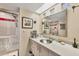 Bathroom featuring a modern sink, mirror, updated shower, and unique decor at 7070 Placida Rd # 1230, Placida, FL 33946