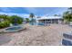 Beautiful community pool area with poolside seating, lush landscaping, and a nearby clubhouse for residents to enjoy at 7070 Placida Rd # 1230, Placida, FL 33946
