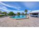 Sparkling community pool featuring a spacious deck, mature palm trees, and inviting lounge chairs for residents at 7070 Placida Rd # 1230, Placida, FL 33946