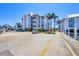 Condo building near boat docks featuring community landscaping and a parking area for residents at 7070 Placida Rd # 1230, Placida, FL 33946