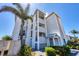 Three-story condo building showcasing private balconies, lush landscaping, and convenient access to docks at 7070 Placida Rd # 1230, Placida, FL 33946