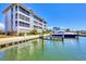 Waterfront condo featuring private boat slip, lush landscaping, and modern architectural design for luxurious living at 7070 Placida Rd # 1230, Placida, FL 33946