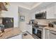 Galley kitchen featuring stainless steel appliances, granite countertops, and ample cabinet space at 7070 Placida Rd # 1230, Placida, FL 33946