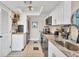 Modern kitchen with white cabinetry, stainless steel appliances, and granite countertops at 7070 Placida Rd # 1230, Placida, FL 33946