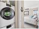 Convenient laundry area with stacked washer and dryer next to a cozy bedroom at 7070 Placida Rd # 1230, Placida, FL 33946