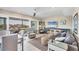 Comfortable living room featuring a balcony, coastal decor, and ample seating at 7070 Placida Rd # 1230, Placida, FL 33946