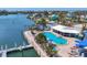 Inviting community pool and spa with waterfront views, complemented by a dock and well-manicured landscaping at 7070 Placida Rd # 1230, Placida, FL 33946