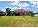 Expansive backyard with lush greenery and a screened-in lanai, creating a private oasis at 76 Sportsman Rd, Rotonda West, FL 33947