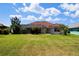 Large backyard with a screened-in lanai and well-maintained lawn at 76 Sportsman Rd, Rotonda West, FL 33947