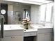 Bathroom features a double sink vanity with a large mirror and decorative floral wallpaper at 76 Sportsman Rd, Rotonda West, FL 33947