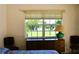 Comfortable bedroom with a window view, dresser and lamps, creating a pleasant atmosphere at 76 Sportsman Rd, Rotonda West, FL 33947