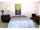Cozy bedroom featuring a comfortable bed, dresser, and a decorative painting enhancing the inviting atmosphere at 76 Sportsman Rd, Rotonda West, FL 33947