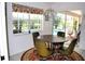 Charming dining area with a view of the pool and backyard at 76 Sportsman Rd, Rotonda West, FL 33947