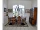 Formal dining area with large window, a statement chandelier, and a lovely vintage china cabinet at 76 Sportsman Rd, Rotonda West, FL 33947