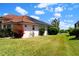 Exterior shot showcasing landscaping, including a view of water, and the property's beautiful tile roof at 76 Sportsman Rd, Rotonda West, FL 33947