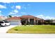 Charming single-story home features a well-maintained lawn, two-car garage, and a beautiful tile roof at 76 Sportsman Rd, Rotonda West, FL 33947