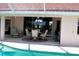 Outdoor lanai with a dining set and sliding glass doors to the interior at 76 Sportsman Rd, Rotonda West, FL 33947