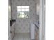 Well-lit laundry room featuring floral wallpaper and essential appliances at 76 Sportsman Rd, Rotonda West, FL 33947