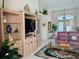 Bright and airy living room boasts tile flooring and neutral walls that extend into the kitchen at 76 Sportsman Rd, Rotonda West, FL 33947